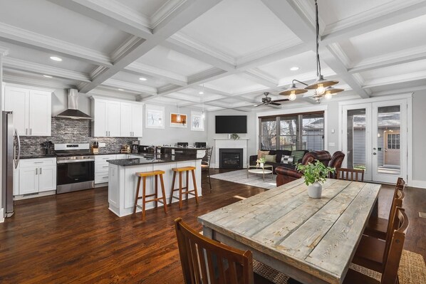 Dining area with seating for eight, right off the kitchen & living areas. Additional seating at the kitchen island. Double doors lead to the fenced-in back yard & patio dining area, which has a grill.