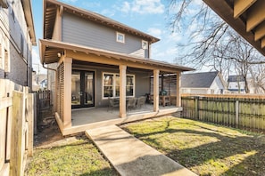 Private, fenced-in backyard. Patio off of the living room with a table, chairs and a Big Green Egg Grill.