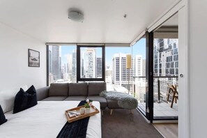 The master bedroom with a queen sized bed & plush pillows.