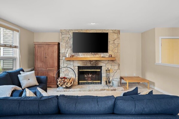 Living room with huge smart tv & fireplace!