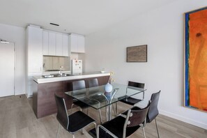 Sit down for a meal together at the glass-topped dining table.