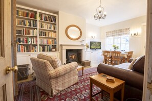 Ground floor: Comfortable seating flanks the wood burning stove at Acorn Cottage, Beamsley