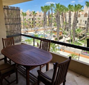 Main Floor Balcony w/Wooden Table, 4 Chairs, Water Cooler, BBQ and Laundry 
