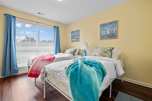 The twin bedroom includes two twin-sized mattresses and a 40" Smart 4K TV