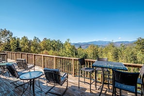 Expansive panoramic deck with unbeatable views of Mt. Washington and Black Mountain. Relax in comfortable seating, dine outdoors, and soak in the fresh mountain air in this stunning retreat.