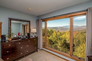 Bedroom #1: Spacious master bedroom with breathtaking views of Mt. Washington and Black Mountain. Features a luxurious king bed, a full private bathroom, and a cozy retreat to wake up to stunning scenery.