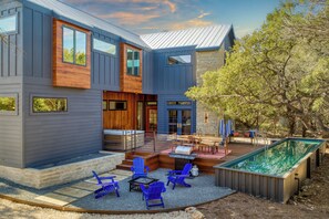 Backyard paradise with a private pool, hot tub, outdoor dining area, and firepit lounge.