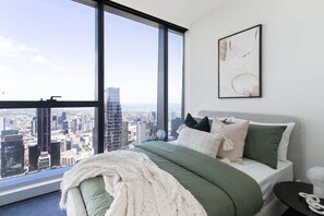 The master bedroom with a queen sized bed & a view.