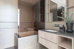 A warm & cozy bathroom with a Japanese bathtub.