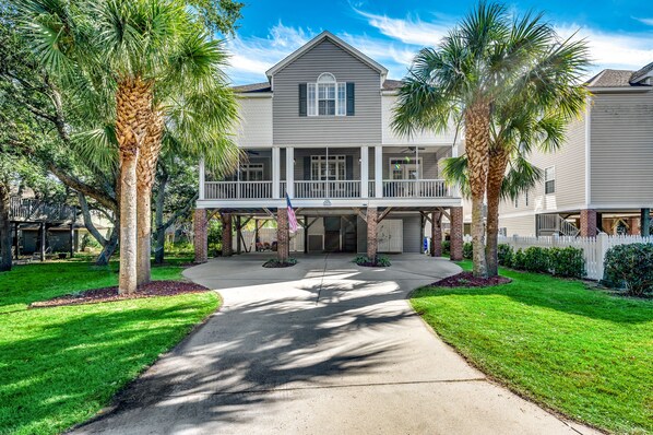 Welcome to your coastal haven, Shore Nuff! Our raised, single family, beach house stands proud, framed by swaying palm trees and a welcoming screened porch that spans the width of the house. The American flag waves, echoing the spirit of seaside freedom. Your escape to sun-soaked bliss begins at the doorstep of this coastal retreat.