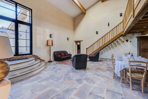 Spacious, bright living room - Large dining table - Wooden china cabinet - 1 3-seater sofa + 2 armchairs - 1 television - Coffee table. 