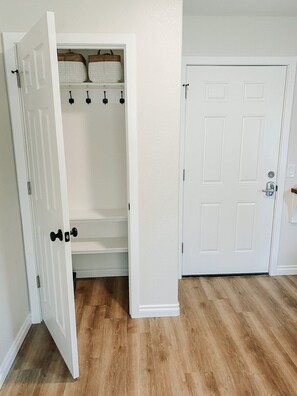 Spacious coat closet with adequate shelving and where you'll find the Dyson stick vacuum should you need it.