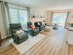 Loveseat and two very nice recliners in the living room area.  The recliners face the TV; however, the view of the forest behind them isn't terrible to look at either.