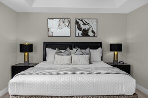 Upstairs master bedroom with bedside nighstand on each side and lamps
