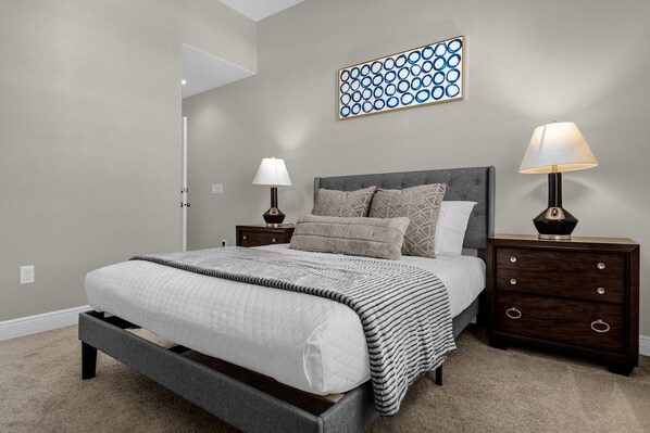 Upstairs bedroom with double side night tables and lamps.