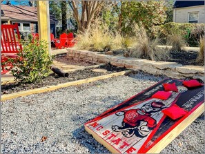 Enjoy a game of cornhole in the yard, perfect for entertaining friends and family.