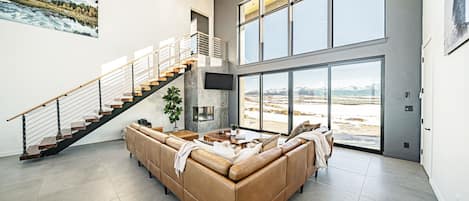 Two story floor-to-ceiling windows offer stunning views and natural light.