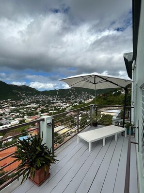 Enjoy sunbathing and the  tropical breeze on your spacious balcony area