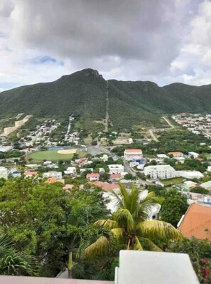 View from rear balcony of zipline attraction and grass filled mountains