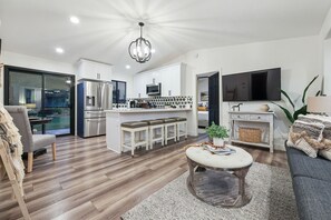 Open floor plan with kitchen, living room, and dining area for 2.