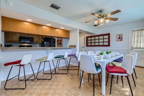 Entertain in style at this dining haven with eight plush seats and four stools