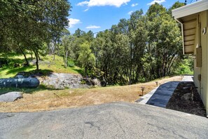 Front area of home that has a creek that does run during certain times of year.