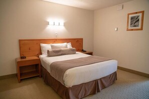 The queen-sized bed is cozy and comfortable