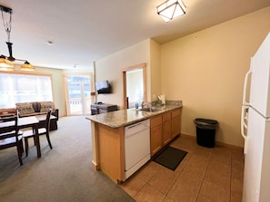 Galley kitchen with solid granite countertops.
