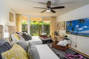 Relax in our cozy bedroom with two beds, modern decor, and direct access to a lush outdoor space. (1)