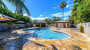 Relax by the sparkling pool in our lush outdoor oasis—perfect for your ultimate getaway experience.