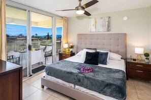 Sleep peacefully in our cozy bedroom with balcony views at 'The Maui Banyan' resort. (1)