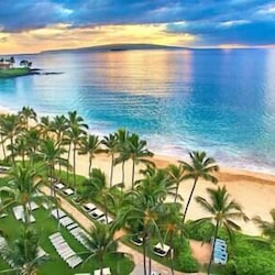Enjoy breathtaking sunsets and pristine beaches at 'The Maui Banyan' resort, your tropical paradise