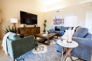 Large Living room with smart tv and open concept kitchen to the living room. 