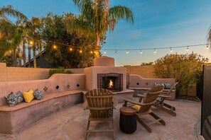Outdoor fireplace with seating are perfect for entertaining at night. 