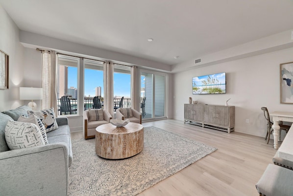 The expansive living area radiates an aesthetic charm, effortlessly blending style with comfort. Its thoughtfully selected decor and abundant seating create an inviting atmosphere perfect for unwinding and socializing.