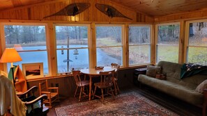 Large porch overlooks the pond and is perfect for morning coffee and a good book