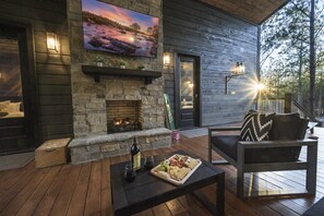 The breezeway is a perfect mix of indoor and outdoor space, complete with a fireplace and TV