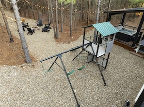 Backyard activities for the whole family! Enjoy relaxing by the fire pit within short distance of our playset