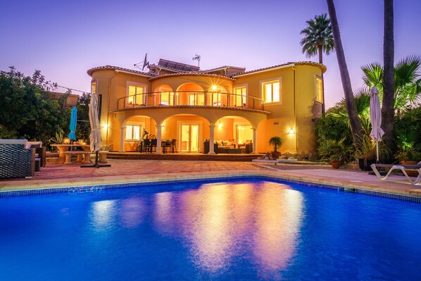 Swimming pool and terrace at night
