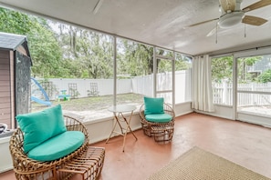Screened in patio with chairs and table