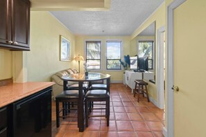 Living Area with AC surrounded by windows, enters natural sunlight. Dining Area