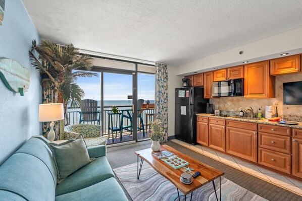 Relax in this oceanfront living room after a day in North Myrtle Beach. Lounge on the cozy couch, take in scenic beach and pool views from the balcony, or unwind under moonlit skies. Features a queen sleeper sofa for extra space and comfort.