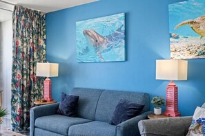 Oceanfront condo with floor-to-ceiling windows, nautical décor, sofa sleeper for 2, and balcony views of Myrtle Beach waves. Relax, stream your favorites, and enjoy coastal comfort in a top-rated location