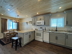 Dine with loved ones in the equipped kitchen overlooking the lake.