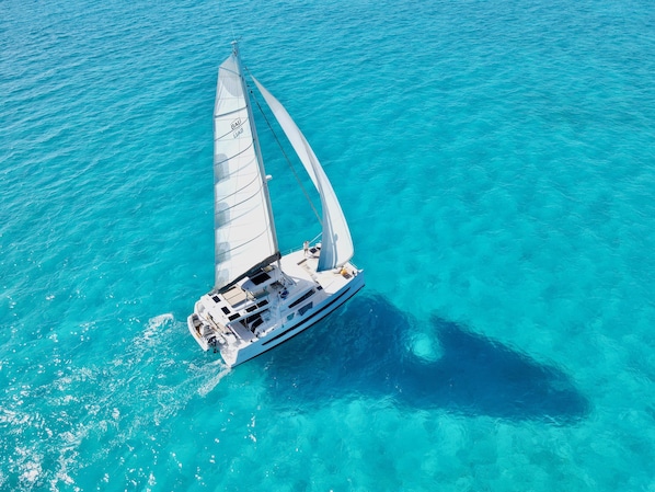 Location Under Sail near Staniel Cay with incredible shadow on ocean floor.