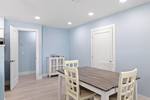 Dining area for up to four guests and in back pictured is the lockout doors that can be opened to make the two bedroom cottage, Caloosa Retreat.