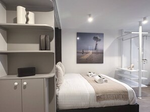 Enjoy a restful night's sleep in this chic bedroom with a queen-size bed