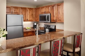 Full kitchen with all the necessities to cook a meal.