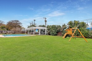 Enjoy your private oasis with a sparkling pool and cozy gazebo, complemented by a vibrant play area for endless fun.