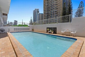 Cool off in the shared swimming pool or unwind in the seating area enjoying some sunshine.
